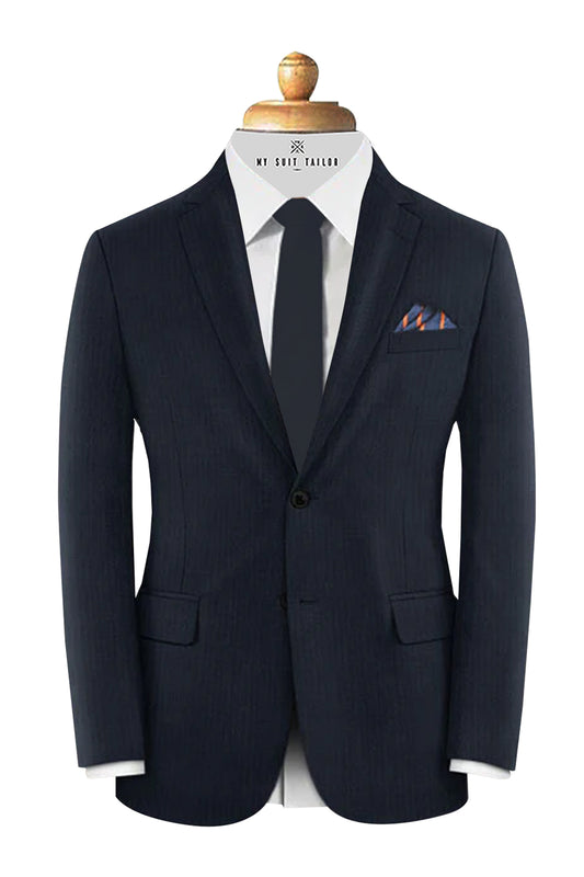 Tailor adjusting client's suit jacket – bespoke fitting session