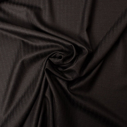 Close-up of black herringbone fabric for a men's tailored suit