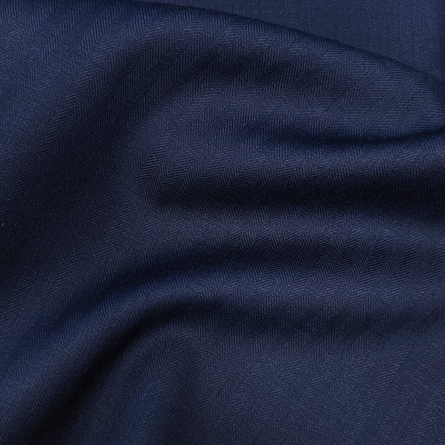 Custom navy herringbone suit on mannequin – men's formalwear