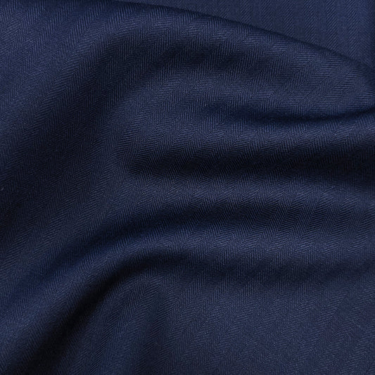Custom navy herringbone suit on mannequin – men's formalwear